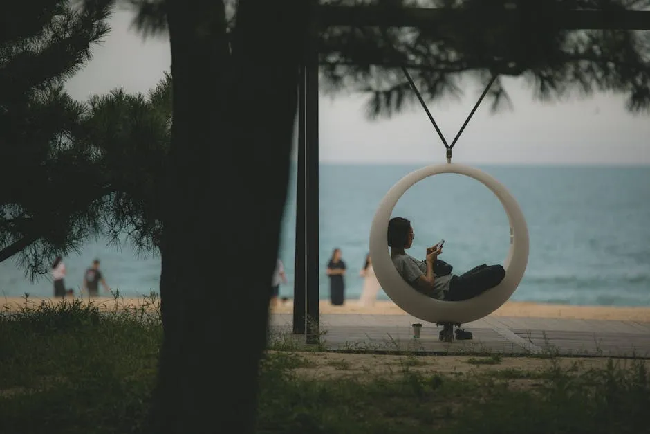 A woman sits in a hanging chair enjoying the beach view in Gangneung, South Korea.