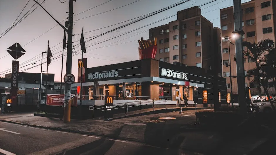 Exterior of modern residential buildings located in suburb near road with signboards and banners and fast food restaurant
