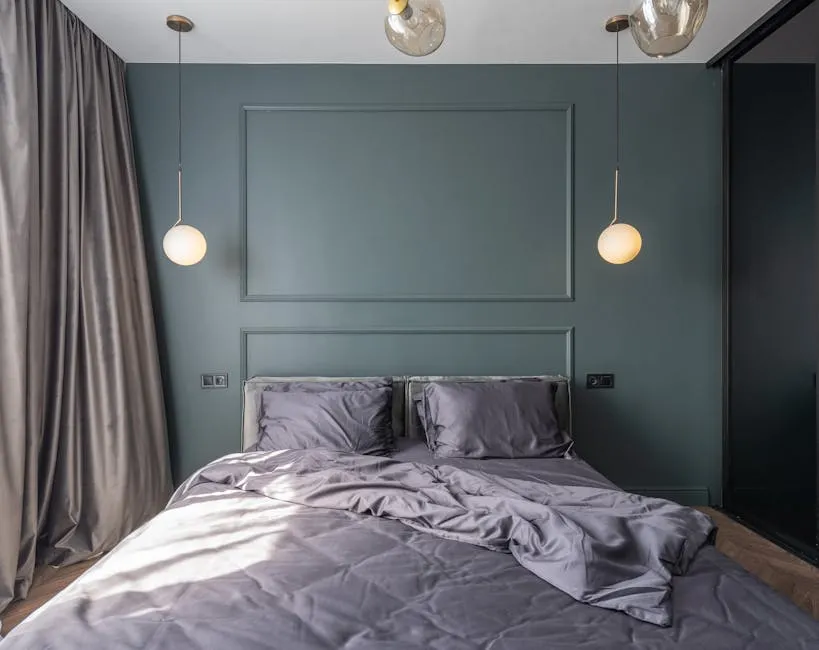 Interior design of modern bedroom with unmade bed under luminous lamps at sunlight