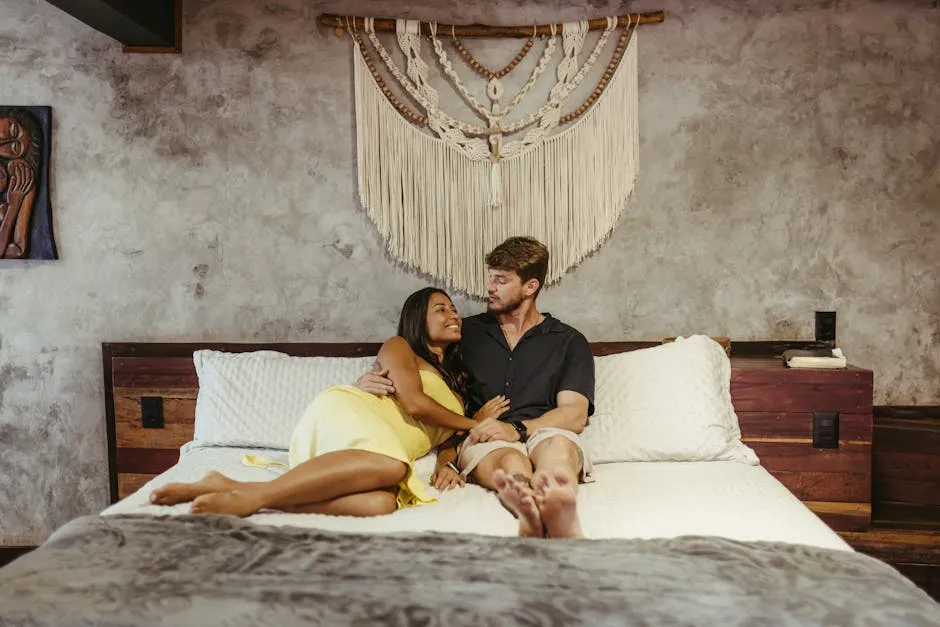 A couple relaxing on a bed with macrame decor, capturing a warm and intimate moment.